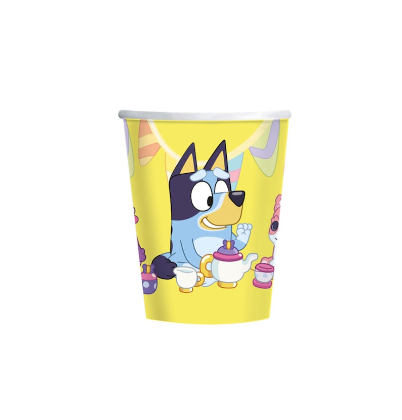 May include: A set of 8 yellow paper cups featuring Bluey and Bingo from the cartoon show Bluey. The cups have a colorful party theme with streamers and a tea party scene.
