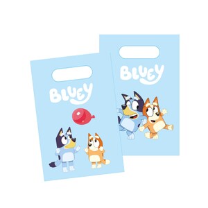 May include: Two blue and orange cartoon dogs on a light blue background. The dogs are holding a red balloon. The text "Bluey" is written in a white, cursive font on the bag.