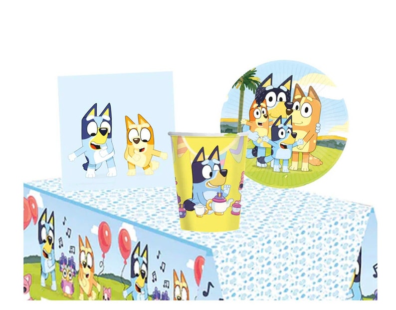 May include: Blue and yellow cartoon dog themed party supplies. The set includes a table cover, paper plates, cups, and napkins. The table cover features a blue and yellow cartoon dog with musical notes. The paper plates feature a blue and yellow cartoon dog with a palm tree in the background. The cups feature a blue and yellow cartoon dog with a teapot and teacups. The napkins feature a blue and yellow cartoon dog with musical notes.
