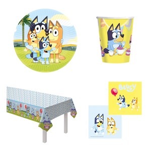 May include: Bluey party supplies featuring a blue and orange dog with a yellow background. The set includes a round paper plate, a paper cup, a table cover, and two napkins.