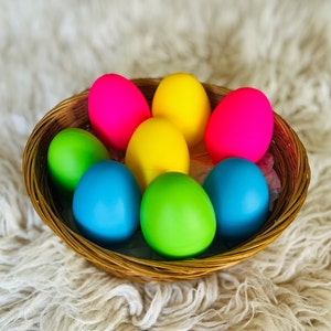 May include: A wicker basket filled with colorful Easter eggs. The eggs are painted in shades of pink, yellow, blue, and green.