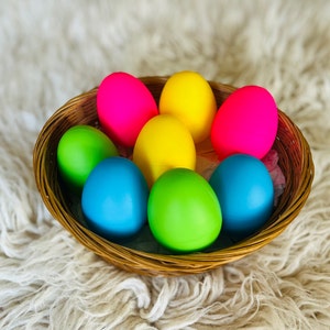 May include: A wicker basket filled with colourful Easter eggs. The eggs are painted in shades of pink, yellow, green, and blue.