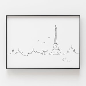 Puede incluir: Un dibujo en blanco y negro de la línea del horizonte de París, con la Torre Eiffel, el Arco del Triunfo y otros edificios. El dibujo está enmarcado en un marco negro y la palabra "París" está escrita en cursiva en la parte inferior.