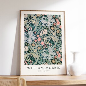May include: A framed print of a floral pattern in shades of green, blue, pink, and yellow. The print is titled "William Morris" and "Golden Lily | 1880".