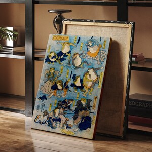 May include: A vintage Japanese woodblock print depicting frogs in various poses, including a frog wearing a samurai helmet and holding a sword. The print is on a blue background with white and yellow accents. The text on the print reads "くくく".