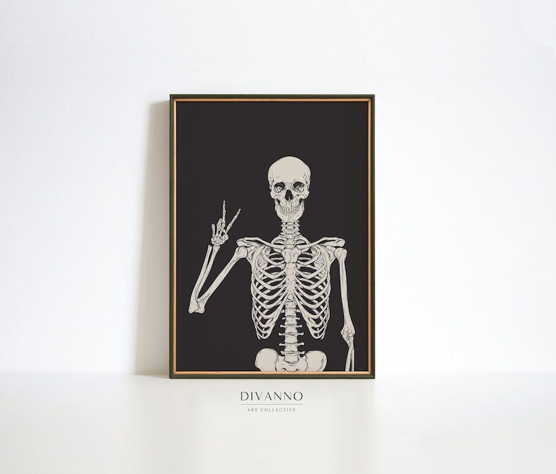 May include: A black and white illustration of a skeleton giving the peace sign. The skeleton is on a black background with the text "DIVANNO ART COLLECTIVE" at the bottom.
