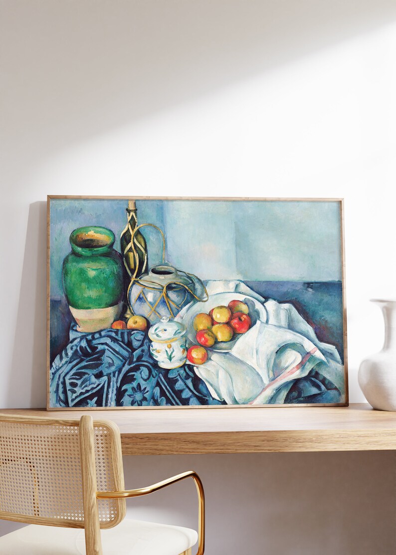 May include: A still life painting featuring a green ceramic vase, a blue and white ceramic pitcher, a white ceramic sugar bowl, and a bowl of red and yellow apples on a blue and white patterned tablecloth.