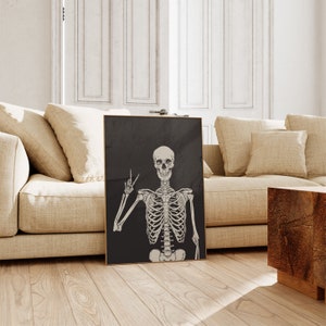 May include: A black and white illustration of a skeleton making a peace sign. The skeleton is on a black background.