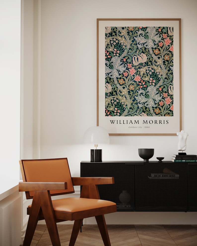 May include: A framed poster featuring a floral pattern in shades of green, blue, pink, and white. The poster is titled "William Morris" with the text "Golden Lily | 1880" below the title.