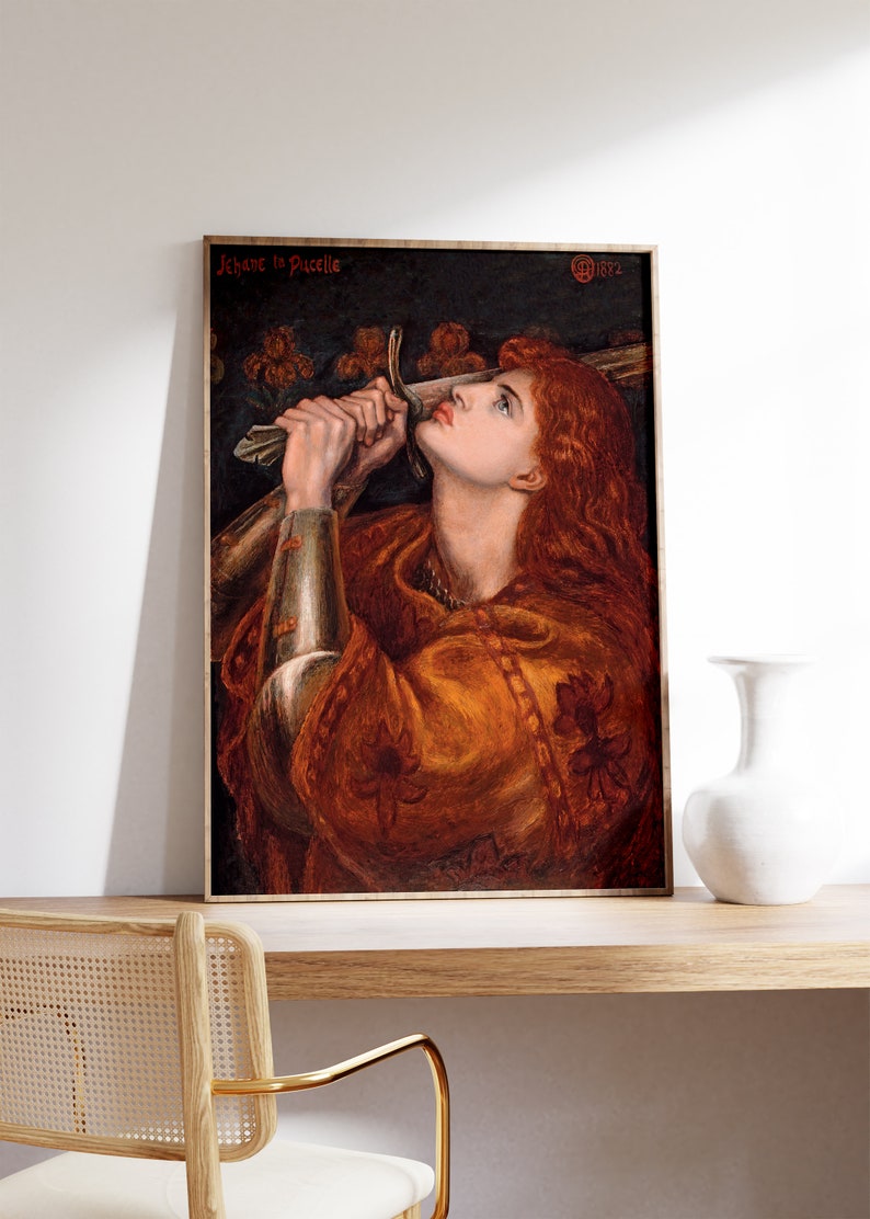 May include: A painting of a woman in armor holding a sword, looking up with a determined expression. The painting is titled "Jeanne la Pucelle" and dated 1882.