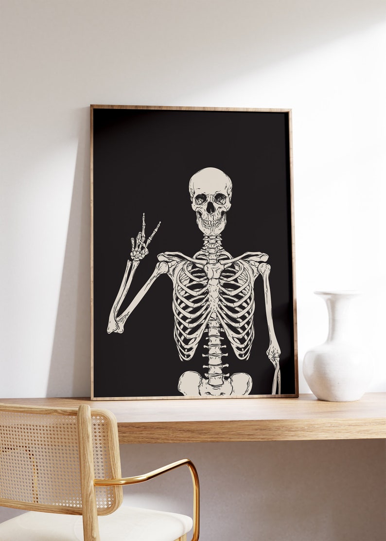 May include: A black and white illustration of a skeleton giving the peace sign. The skeleton is on a black background.