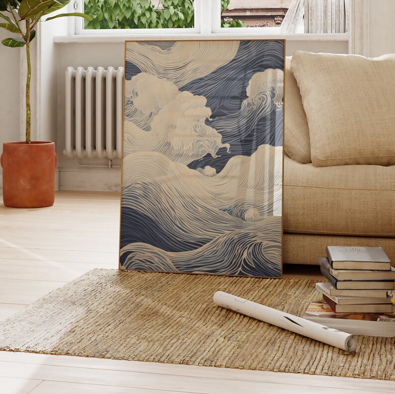 May include: A framed print of a blue and white abstract wave design. The waves are drawn with thin lines and create a sense of movement. The print is hanging on a wall in a living room setting.