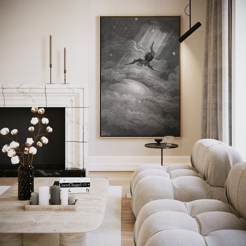 May include: A black and white print of a winged figure falling from the sky, surrounded by clouds. The print is framed and hanging on a white wall in a modern living room.