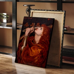 May include: A painting of a woman holding a sword, with a red and gold robe, and long red hair. The painting is titled "Jeanne la Pucelle" and dated 1882.