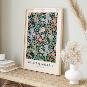 May include: A framed print of a vintage floral pattern in shades of green, blue, pink, and yellow. The print is titled "William Morris Golden Lily 1880".