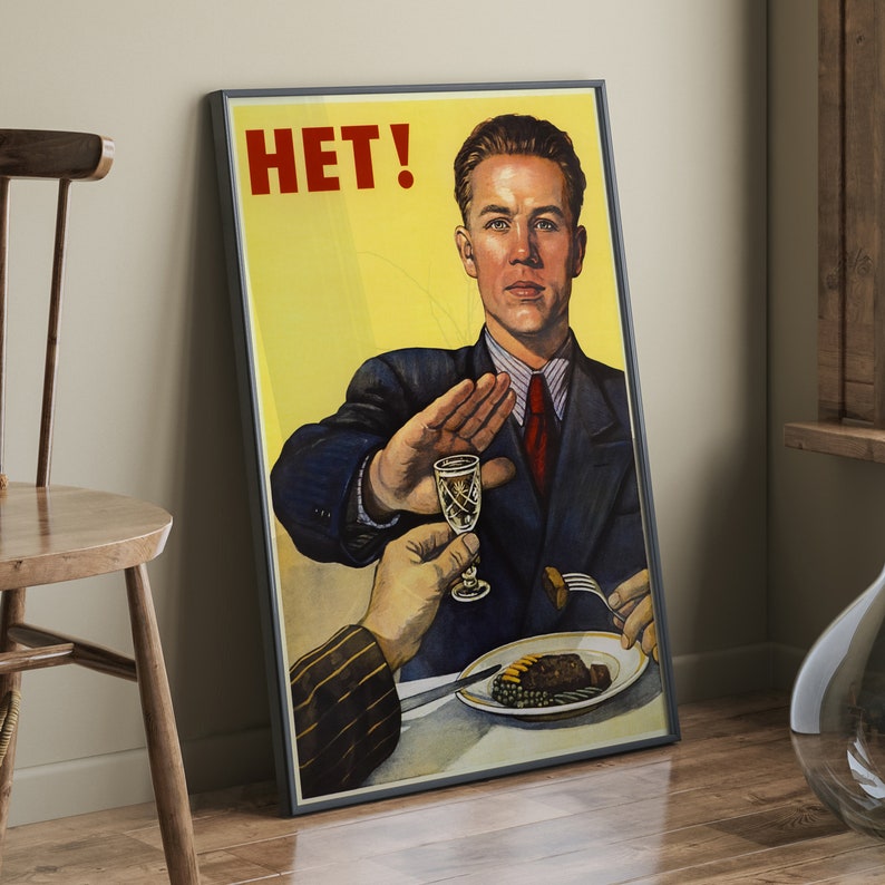May include: A vintage propaganda poster with a man in a suit saying "HET!" while holding up his hand to refuse a glass of alcohol. The poster has a yellow background and features a hand reaching towards the man with a glass of alcohol.