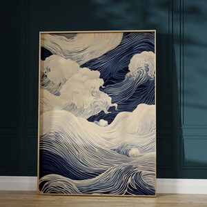 May include: A framed abstract art print with a blue and cream color scheme. The print features a stylized design of waves and clouds.