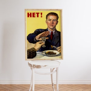May include: A vintage Soviet-style propaganda poster with a man in a suit saying "HET!" while holding up his hand to refuse a glass of alcohol. The poster has a yellow background and is framed in wood.
