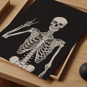 May include: A black and white illustration of a skeleton giving the peace sign. The skeleton is drawn in a detailed anatomical style.
