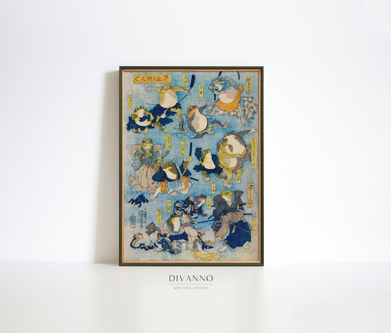 May include: A vintage Japanese woodblock print depicting frogs in various poses, some wearing samurai armor and holding swords. The print is framed in a brown wood frame and has the text "くくもく" in the top left corner.