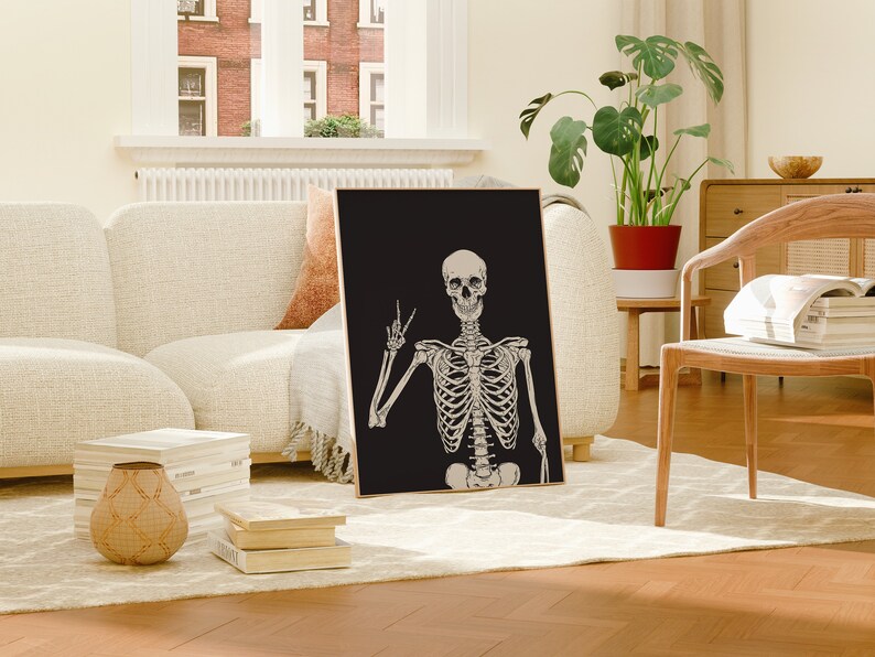 May include: A black and white poster featuring a skeleton giving the peace sign. The skeleton is on a black background.