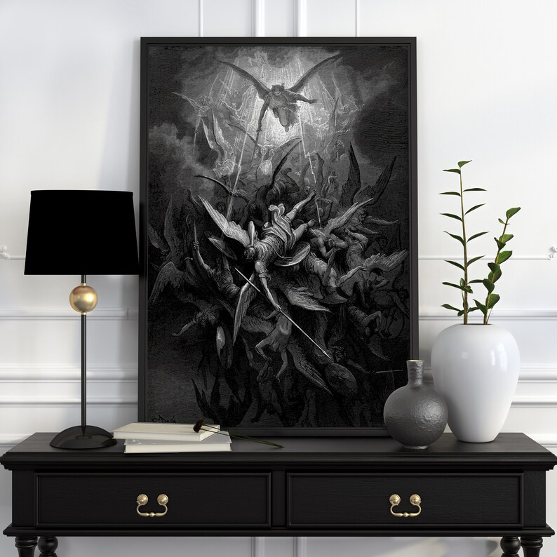 May include: A black and white illustration of a scene from Dante's Inferno, depicting angels falling from heaven. The image is framed in a black frame and is hanging on a white wall.