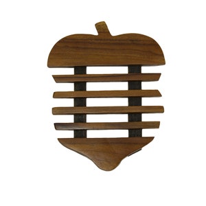 May include: A wooden pot holder shaped like an apple with a slatted design. The holder is brown and has a natural wood finish.