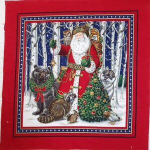 May include: A fabric square featuring a Christmas scene with Santa Claus in a red coat, surrounded by forest animals. The background shows a snowy forest with birch trees and a starry night sky. A Christmas tree is in the center.