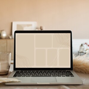May include: A silver laptop computer with a black screen displaying a beige background with thin brown lines and a grid of five beige squares. The laptop is sitting on a light brown surface.