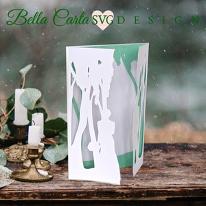 This beautiful hand-made card depicts a wedding bride and groom in an enchanted forest surrounded by a cathedral of trees.