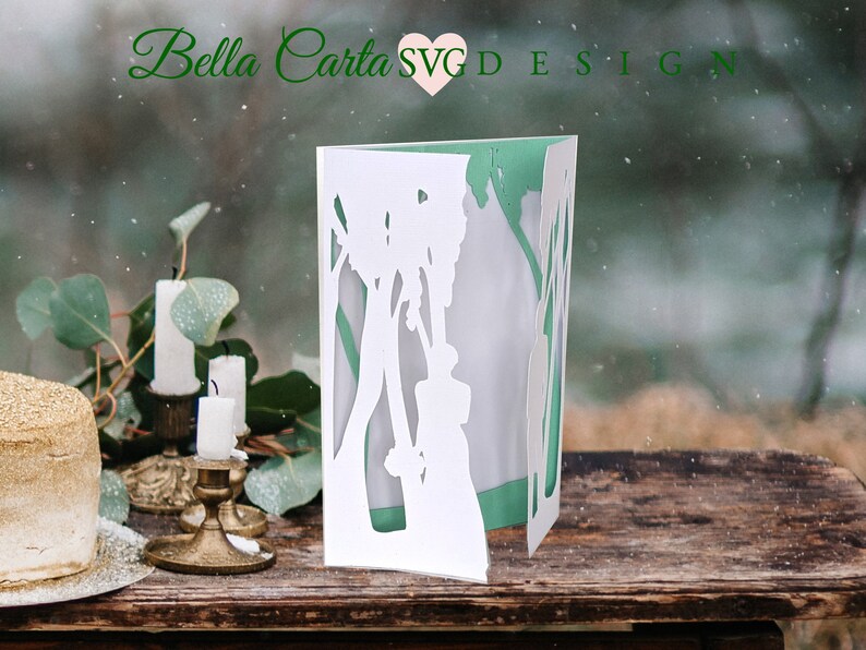 This beautiful hand-made card depicts a wedding bride and groom in an enchanted forest surrounded by a cathedral of trees.