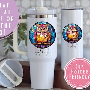 May include: White insulated tumblers with a colorful owl design. The owl is in a stained glass style, with pink, yellow, and blue hues. The name "Abbey" is written below the owl. The tumblers are cup holder friendly.