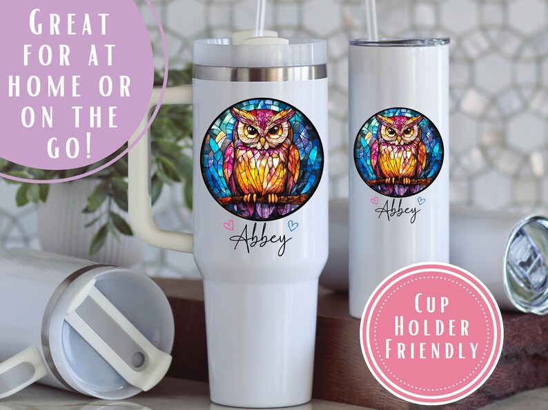May include: White insulated tumblers with a colorful owl design. The owl is in a stained glass style, with pink, yellow, and blue hues. The name "Abbey" is written below the owl. The tumblers are cup holder friendly.