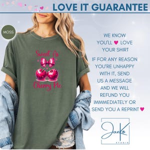 May include: A green t-shirt with the text "Sweet As Cherry Pie" in pink lettering. The text is accompanied by a graphic of two cherries with a pink bow on top. The shirt is being modeled by a person. The text "LOVE IT GUARANTEE" is at the top of the image. The text "WE KNOW YOU'LL LOVE YOUR SHIRT" is on the right side of the image. The text "IF FOR ANY REASON YOU'RE UNHAPPY WITH IT, SEND US A MESSAGE AND WE WILL REFUND YOU IMMEDIATELY OR SEND YOU A REPRINT" is on the right side of the image. The text "Janko STUDIO" is at the bottom of the image.