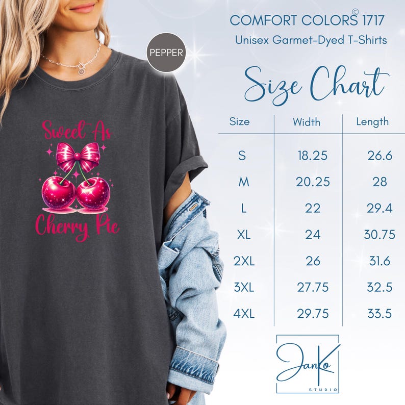 May include: A dark gray t-shirt with a pink cherry pie graphic and the text "Sweet as Cherry Pie". The shirt is a unisex garment-dyed t-shirt. A size chart is included with measurements in inches.