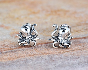 May include: A pair of silver octopus stud earrings. The octopus is detailed with eight tentacles and a round head.