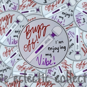 May include: A white sticker with the text "Buzz Off! I'm enjoying my Vibe!" in purple and red lettering. A purple and white toy is pictured on the sticker. The sticker is surrounded by other stickers with the same design.