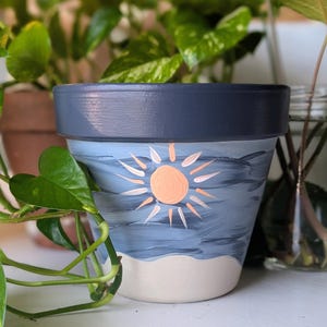 May include: A set of three ceramic mugs with a speckled, matte finish. The mugs are in shades of cream, light gray, and dark gray. Each mug has a simple, minimalist design, perfect for coffee or tea.