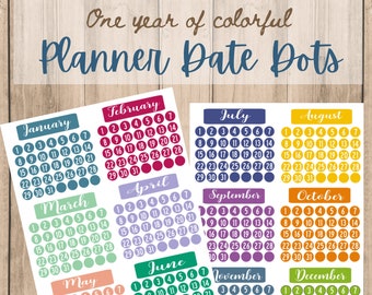 May include: A set of 12 colorful monthly calendar planner stickers with date dots. Each month is represented by a different color. The months are January, February, March, April, May, June, July, August, September, October, November, and December.