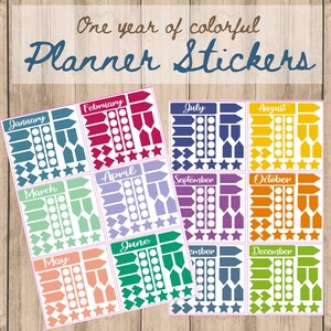 May include: A set of 12 monthly planner stickers featuring colorful arrows, stars, and circles. Each month is represented by a different color. The stickers are labeled with the months of the year: January, February, March, April, May, June, July, August, September, October, November, and December.