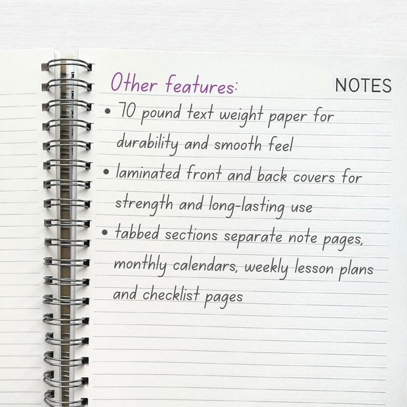 May include: A close-up of a notebook with a spiral binding. The notebook has lined pages and the text "Other features:" and "NOTES" is written on the page. The text lists features of the notebook, including 70 pound text weight paper, laminated covers, tabbed sections, monthly calendars, weekly lesson plans, and checklist pages.