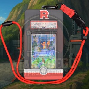 May include: A gray card holder with a red lanyard, featuring a Pok&eacute;mon trading card. The card displays a Charmander illustration with the text "Heat Tackle." The holder has the letter "R" and text that reads "2023 Pokemon SVP EN Charmander Obsidian Flames ETB."