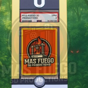 May include: A yellow, white, and black card holder with the text "MAS FUEGO 3D PRODUCTIONS" and "MINT 9". The holder has a large white "U" on top and a circular button at the bottom. The background is a green forest.
