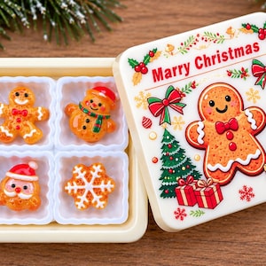 May include: A square cream-colored box with a lid featuring a gingerbread man, Christmas trees, and the text Marry Christmas. Inside are four white compartments containing small resin figures of a gingerbread man, snowman, Santa, and snowflake.