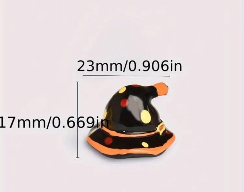 May include: A miniature black witch hat with orange and yellow polka dots and trim. The hat is 0.906 inches wide and 0.669 inches tall, perfect for Halloween decorations or crafts.