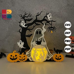 May include: A Halloween-themed wooden decoration featuring a glowing pumpkin lantern, ghosts, bats, and a spider. The design includes a tree silhouette and jack-o'-lanterns, creating a spooky scene. The color palette is black, orange, and white.