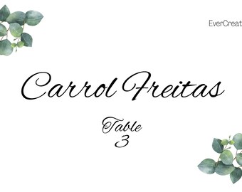 May include: White table card with the name "Carrol Freitas" in elegant script, and "Table 3" below. Watercolor eucalyptus branches frame the top left and bottom right corners. The EverCreativeByEva logo is in the top right.