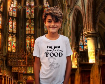 May include: White t-shirt with a black graphic that says "I'm just here for the FOOD" with a stylized image of a chalice and bread.