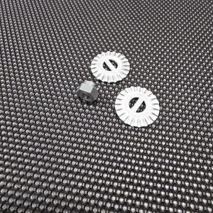 May include: Two silver cookie cutters with a decorative design and a silver nut on a black textured surface.