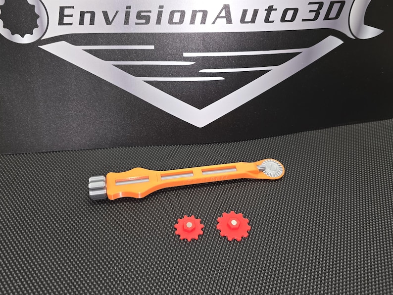 May include: Orange and gray plastic tool with a gear on one end and a handle on the other. Two orange plastic gears are also included.